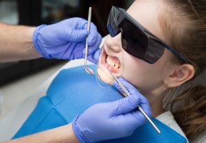 Child receiving a dental checkup from a dentist