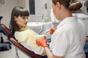 Dentist examining a patient's tooth for signs of root canal infection